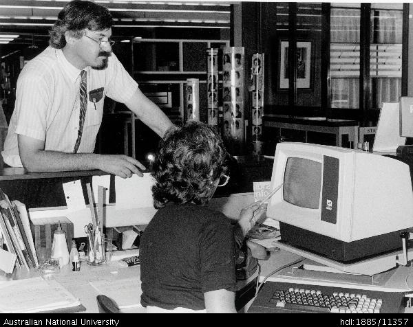 Tony Barry, ANU Deputy University Librarian, inspecting computerised library system in 1986